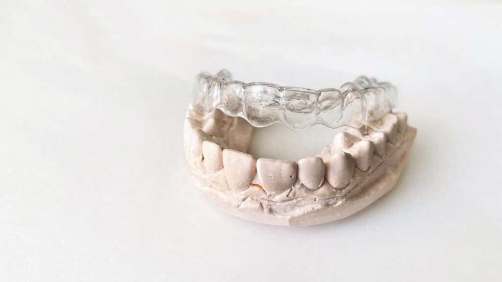 Transparent invisible dental aligners or braces applicable for an orthodontic dental treatment
